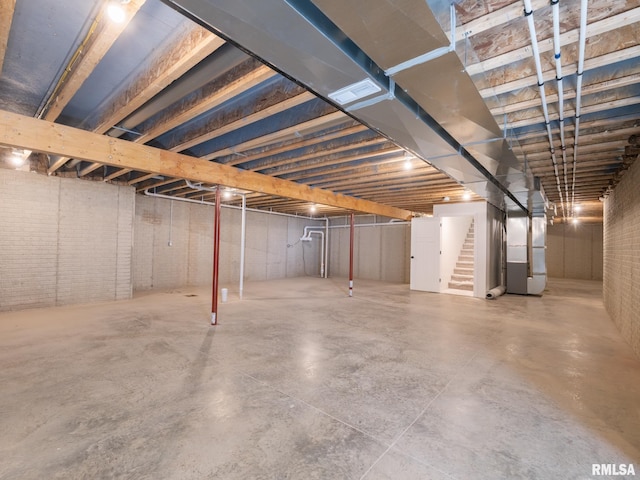 unfinished below grade area with stairway and heating unit