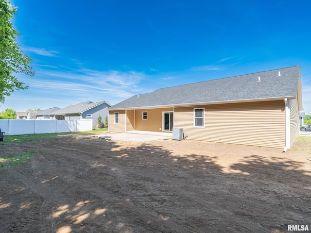rear view of house featuring a patio area, fence, and cooling unit