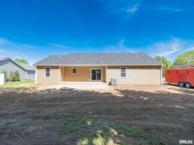 rear view of house with a patio area and central AC