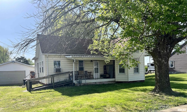 1428 N Main St, Lewistown, IL 61452 - view of front facade with a porch, a front lawn, a garage, roof with shingles, and an outdoor structure