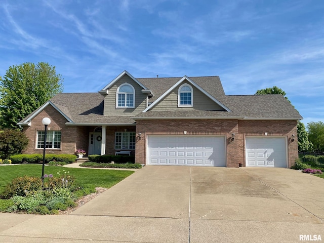 11506 N Bristol Dr, Dunlap, IL 61525 - traditional home with brick siding, concrete driveway, a front lawn, roof with shingles, and an attached garage
