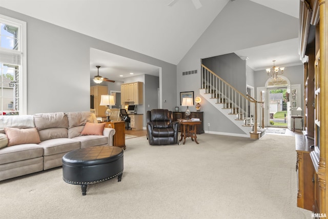 11506 N Bristol Dr, Dunlap, IL 61525 - living room featuring ceiling fan, high vaulted ceiling, light colored carpet, stairs, and a chandelier