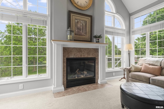 11506 N Bristol Dr, Dunlap, IL 61525 - carpeted living room with vaulted ceiling, baseboards, and a fireplace