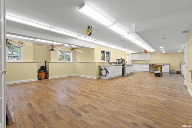 11506 N Bristol Dr, Dunlap, IL 61525 - below grade area with light wood-style flooring, baseboards, and a chandelier