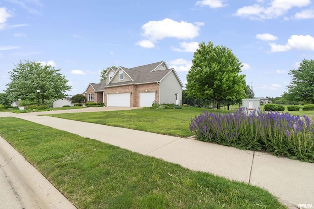 11506 N Bristol Dr, Dunlap, IL 61525 - view of front facade featuring brick siding, a front yard, driveway, and a garage