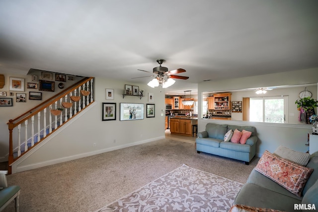 15207 N 7th St, Chillicothe, IL 61523 - living room featuring a ceiling fan, light carpet, stairs, and baseboards