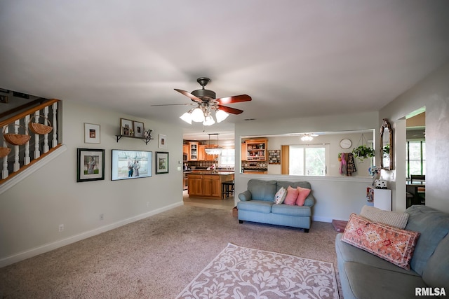 15207 N 7th St, Chillicothe, IL 61523 - living room featuring ceiling fan, stairway, light carpet, and baseboards