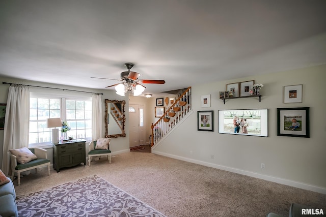 15207 N 7th St, Chillicothe, IL 61523 - living area featuring light colored carpet, stairway, ceiling fan, and baseboards