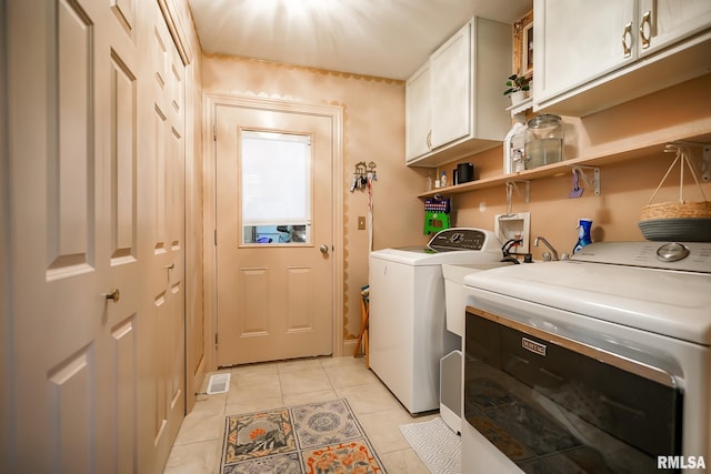 15207 N 7th St, Chillicothe, IL 61523 - washroom with washer and clothes dryer, cabinet space, and light tile patterned flooring
