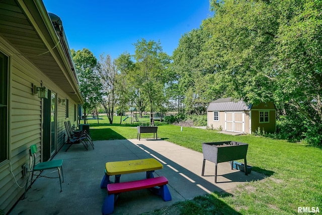 15207 N 7th St, Chillicothe, IL 61523 - view of community featuring a patio, a shed, a lawn, and an outbuilding