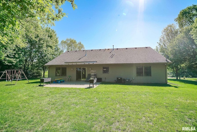 15207 N 7th St, Chillicothe, IL 61523 - rear view of property with a patio area, a yard, a playground, and a shingled roof