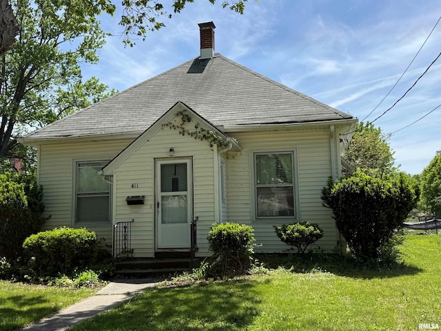 411 W Jefferson St, Macomb, IL 61455 - view of front of property with a front lawn and a chimney