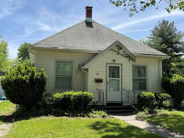 411 W Jefferson St, Macomb, IL 61455 - view of front of home with a chimney and a front yard