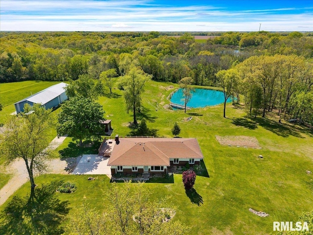 view from above of property with a pool area and a forest