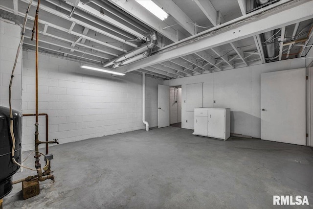 unfinished basement with concrete block wall