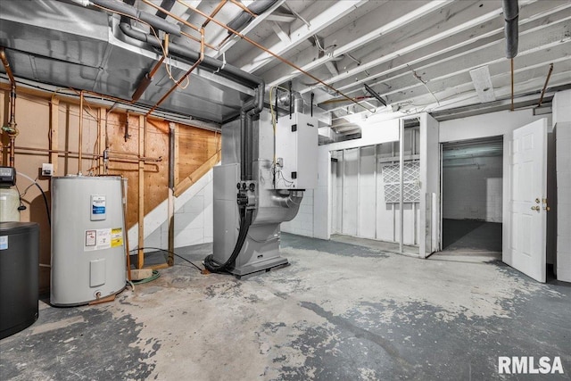 unfinished below grade area featuring water heater and heating unit
