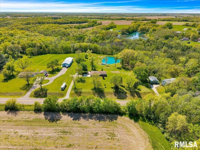 drone / aerial view of a large body of water and a heavily wooded area
