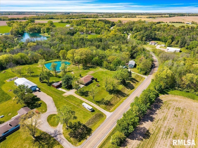 aerial view of property's location with a pool and a nearby body of water