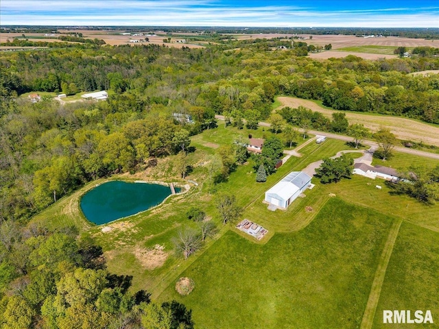 view of property location with a large body of water and a forest