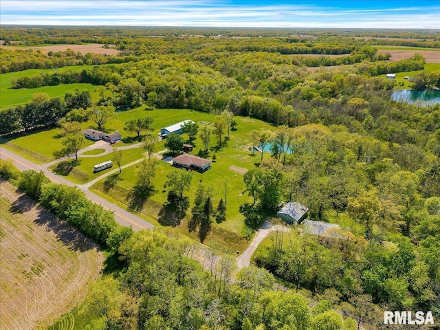 drone / aerial view of a large body of water and a heavily wooded area