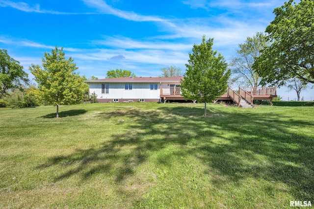 view of green lawn featuring a deck