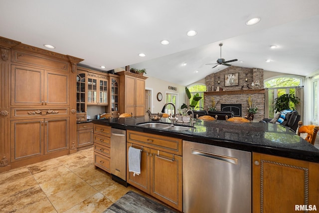 kitchen with dishwasher, a sink, ceiling fan, plenty of natural light, and lofted ceiling