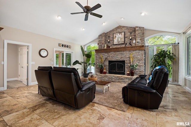 living area featuring healthy amount of natural light, ceiling fan, a fireplace, baseboards, and high vaulted ceiling