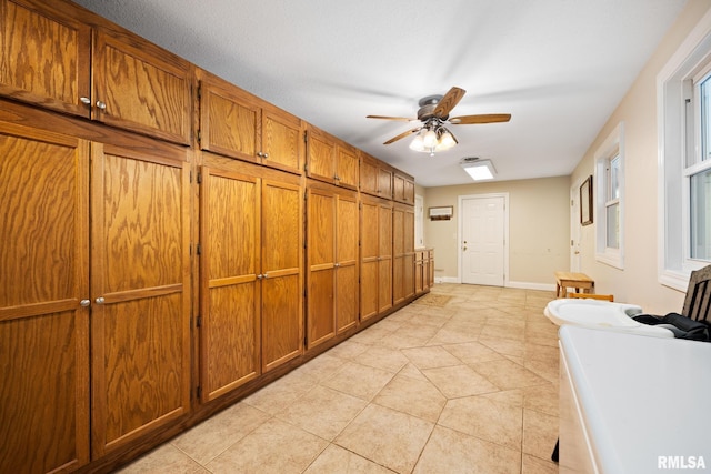 corridor featuring light tile patterned flooring and baseboards