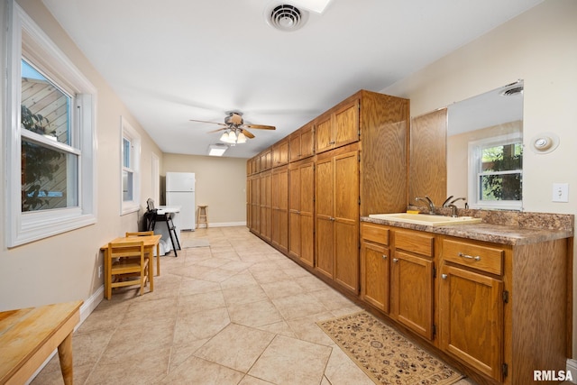 corridor featuring a sink and light tile patterned floors