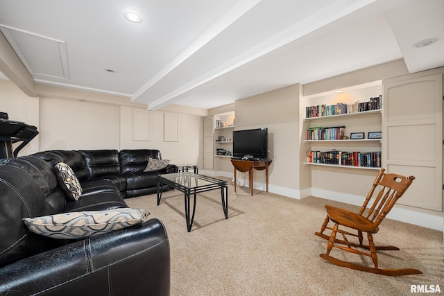 carpeted living room featuring baseboards and attic access