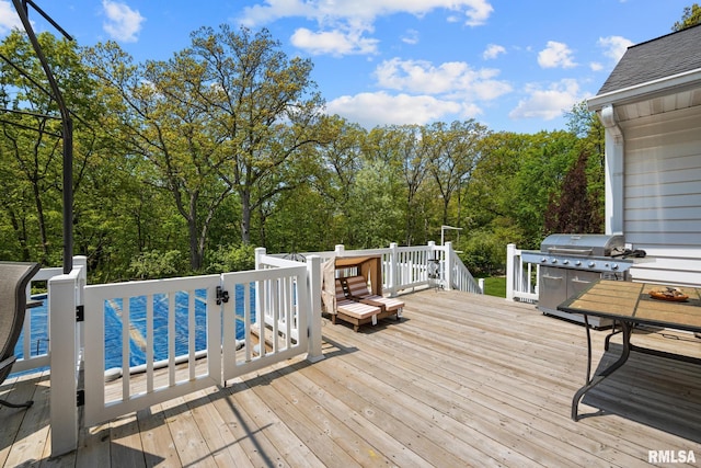 wooden deck featuring area for grilling