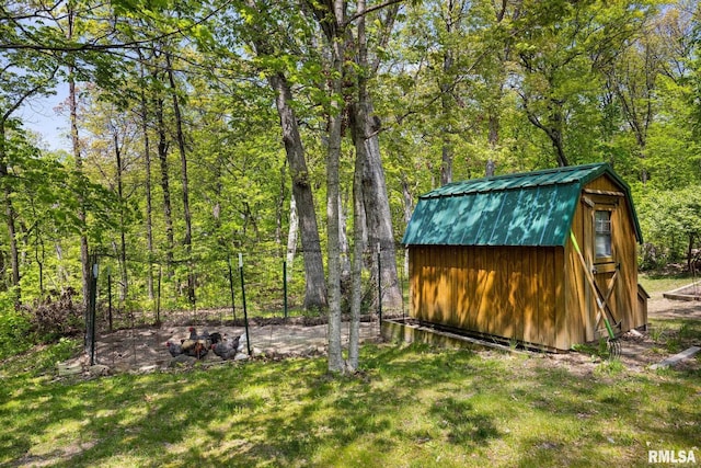 view of shed featuring a forest view