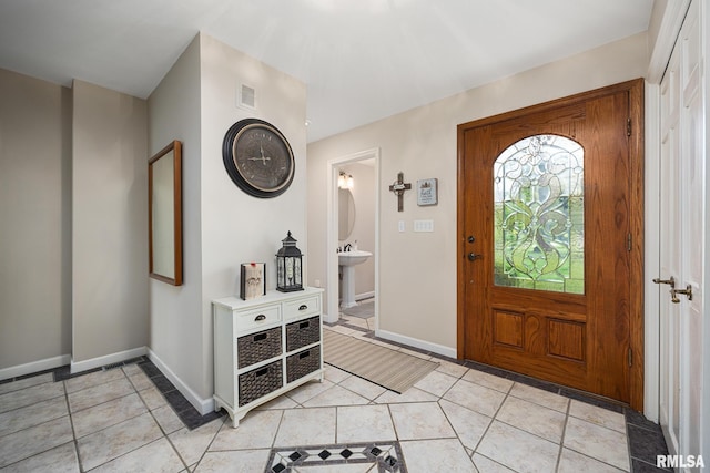 entryway featuring light tile patterned flooring and baseboards