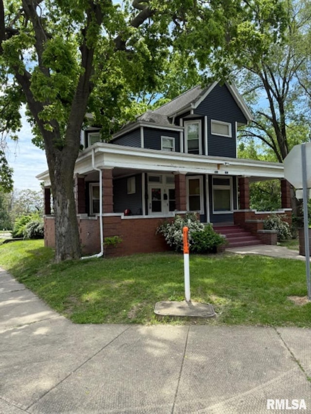 2826 NE Madison Ave, Peoria, IL 61603 - view of front of house featuring covered porch and a front lawn
