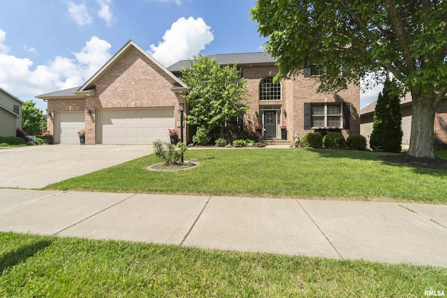 traditional-style house featuring brick siding, an attached garage, a front lawn, and concrete driveway