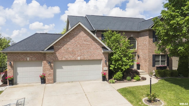 view of front of home with brick siding, a shingled roof, concrete driveway, a front lawn, and an attached garage