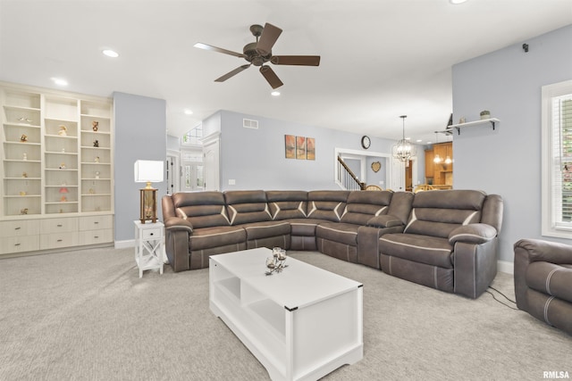carpeted living area featuring ceiling fan, recessed lighting, a chandelier, and baseboards