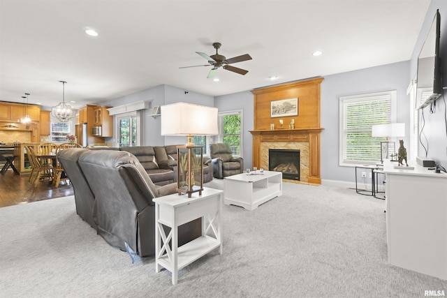 living room featuring ceiling fan, healthy amount of natural light, a high end fireplace, and recessed lighting