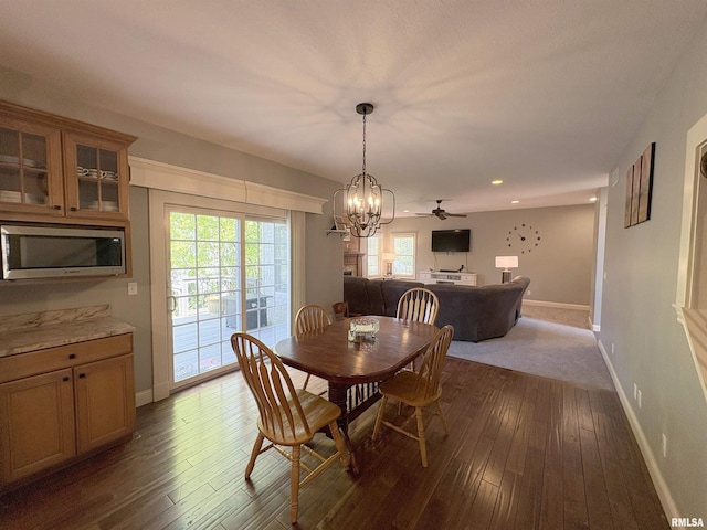 dining room featuring dark wood-style flooring, baseboards, a chandelier, and recessed lighting
