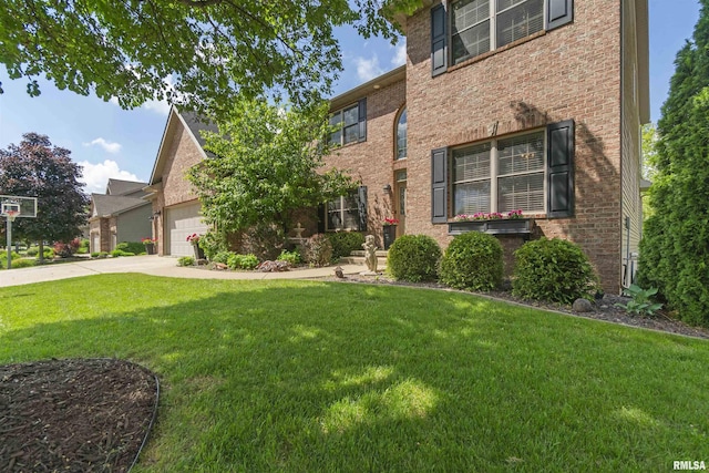 view of front of property with a front yard, a garage, concrete driveway, and brick siding