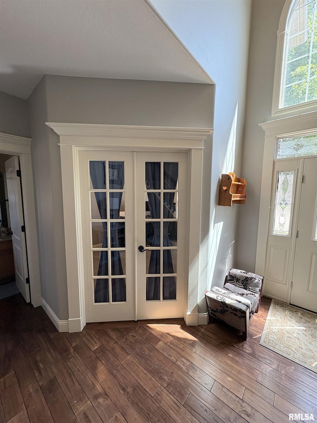 entryway featuring dark wood finished floors, baseboards, and french doors