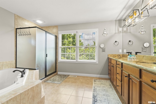 full bathroom featuring double vanity, a garden tub, a shower stall, and baseboards