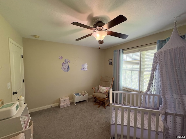 bedroom with carpet, ceiling fan, baseboards, and a textured ceiling