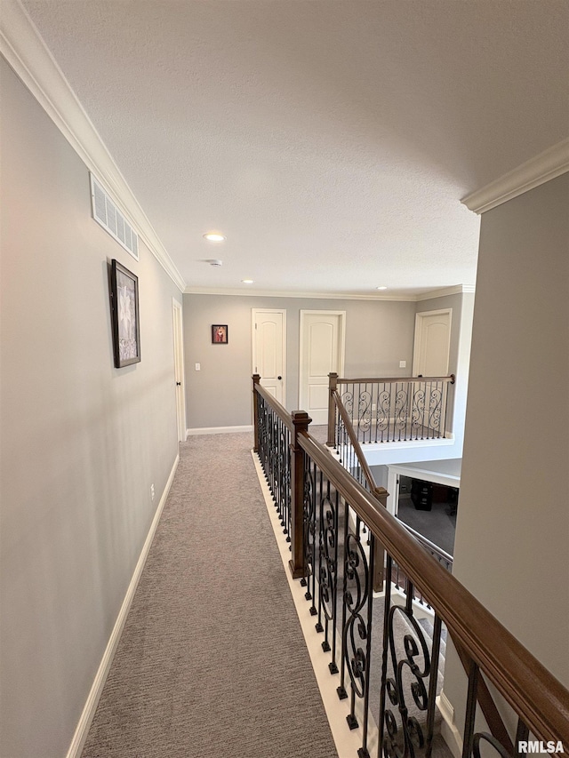 corridor with crown molding, recessed lighting, an upstairs landing, carpet flooring, and baseboards