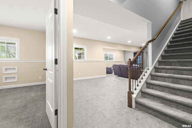 stairs with carpet floors, baseboards, and recessed lighting