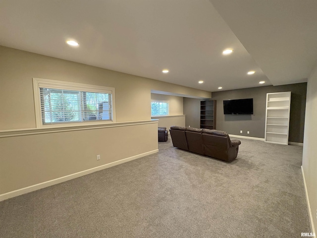 living room with carpet floors, baseboards, recessed lighting, and built in features