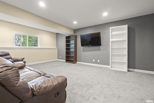 carpeted living area with baseboards and recessed lighting