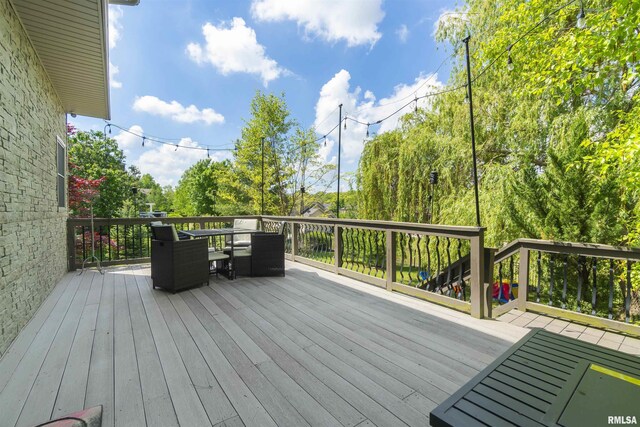 wooden deck featuring outdoor dining area
