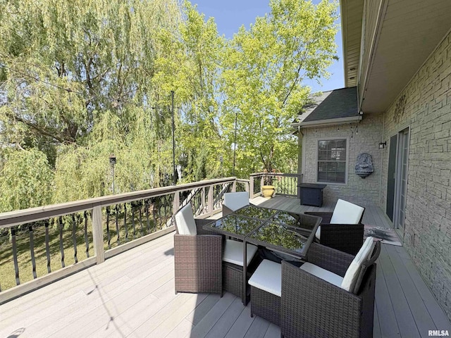 wooden terrace featuring outdoor dining space