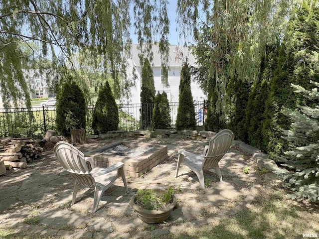 view of patio / terrace featuring fence and an outdoor fire pit